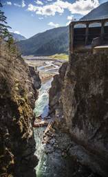 What’s left of the 210-foot-high Glines Canyon Dam, a section of about 30 feet, is awaiting a final blast in September. In the distance, the bottom of former Lake Mills today forms part of the new Elwha Valley. 